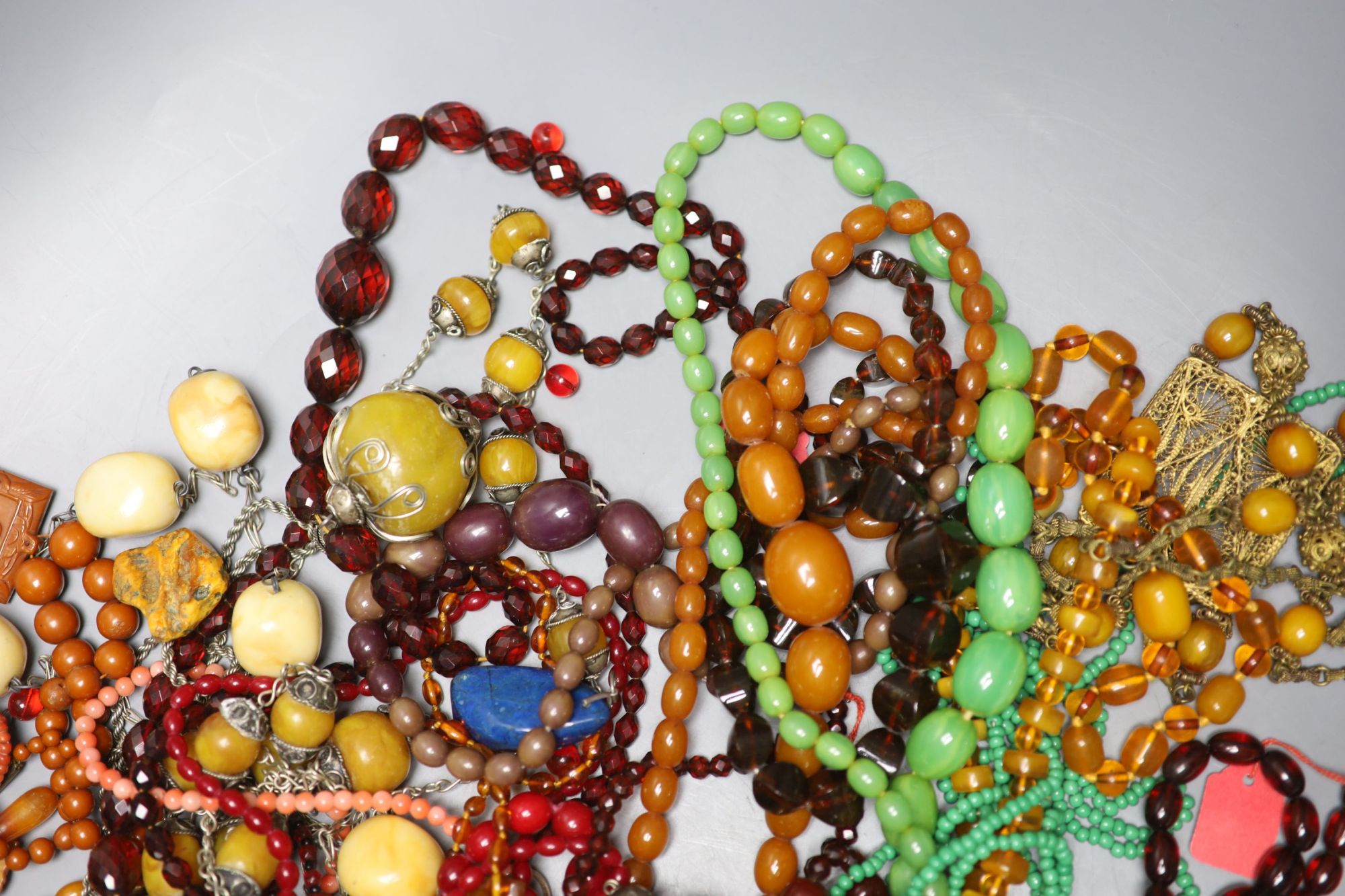 A group of assorted costume jewellery including faux amber etc.